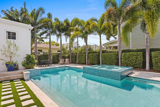 view of swimming pool featuring an in ground hot tub, a patio area, fence, and a fenced in pool