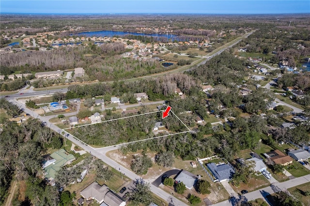 aerial view with a water view and a forest view