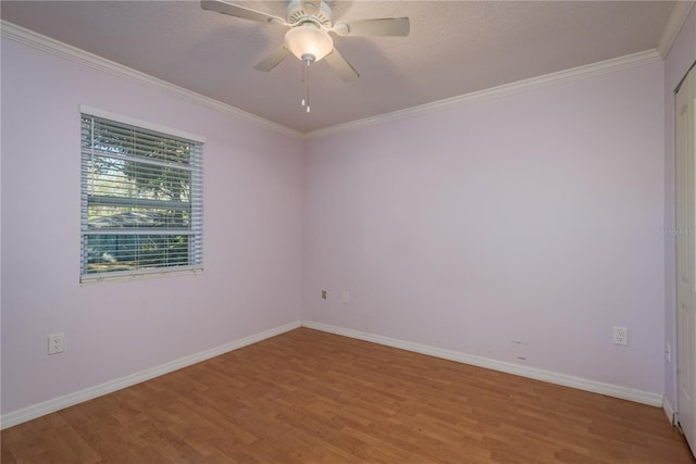 spare room featuring light wood-style floors, baseboards, and ornamental molding