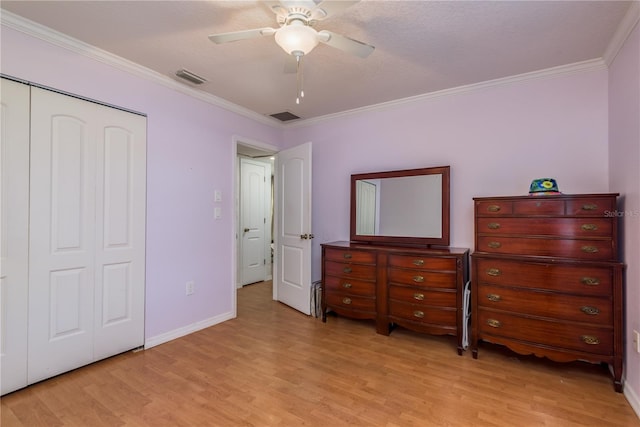 bedroom with light wood-style floors, visible vents, and crown molding