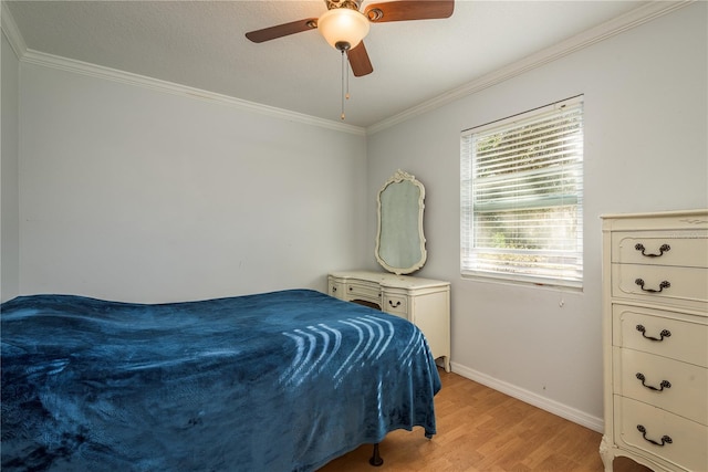 bedroom with light wood-style floors, crown molding, baseboards, and ceiling fan