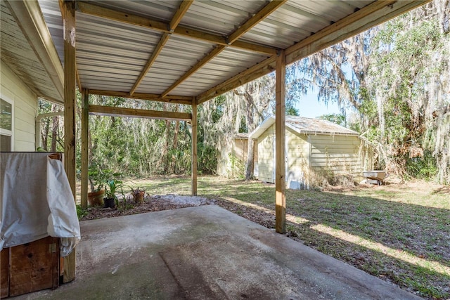 view of patio featuring an outbuilding and a storage shed