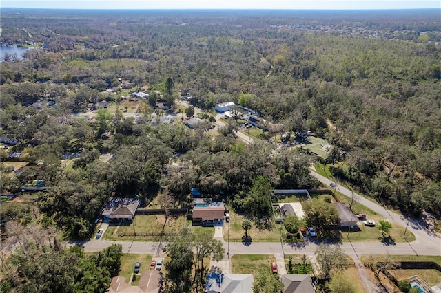 aerial view featuring a water view and a view of trees