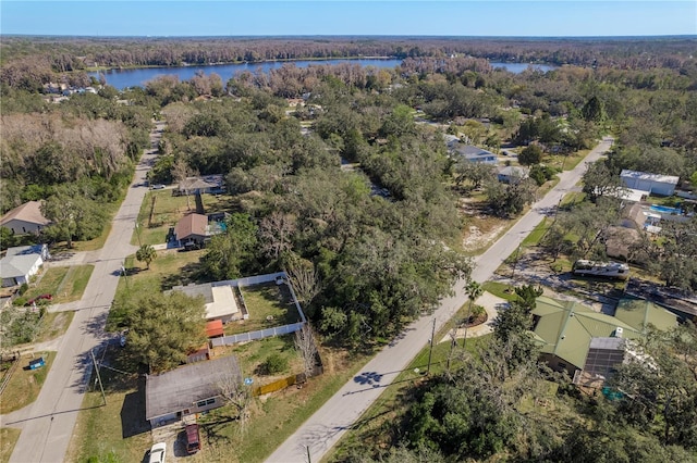 drone / aerial view featuring a forest view and a water view