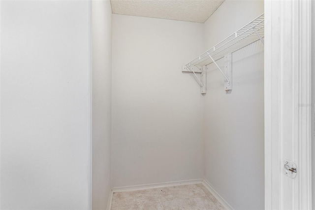 walk in closet featuring light tile patterned floors