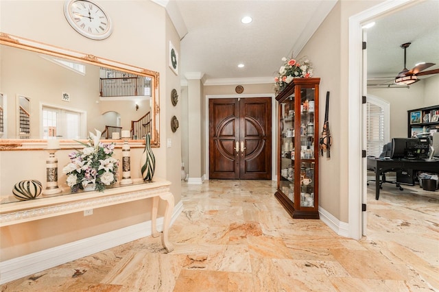 foyer featuring ornamental molding, stairway, a ceiling fan, and baseboards