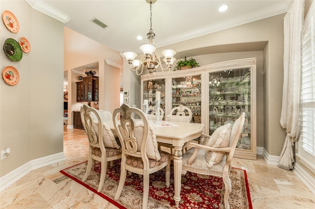 dining area with baseboards, a chandelier, and ornamental molding