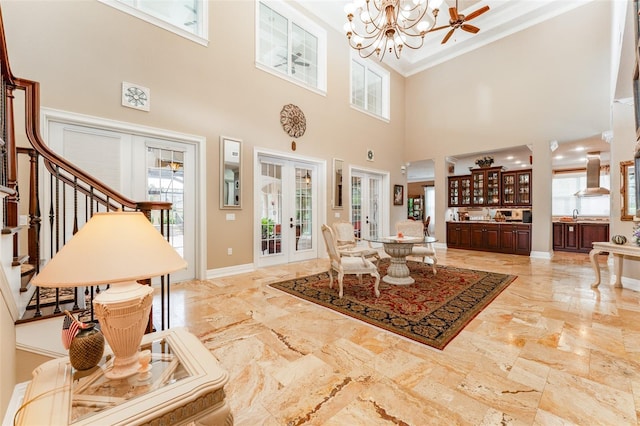 dining room featuring french doors, stairway, an inviting chandelier, ornamental molding, and baseboards