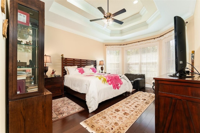 bedroom featuring crown molding, a ceiling fan, a raised ceiling, and wood finished floors