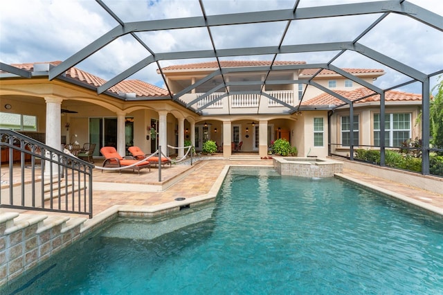 view of pool with a ceiling fan, a pool with connected hot tub, and a patio