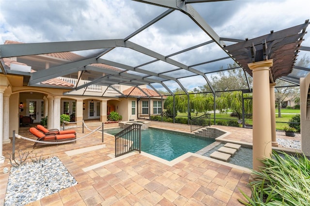 view of pool with a pool with connected hot tub, french doors, a patio, and a lanai