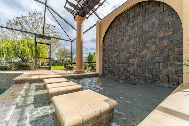 view of patio featuring a lanai