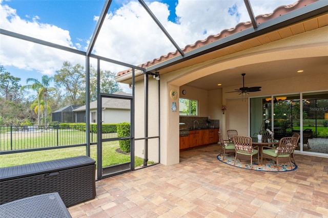 sunroom featuring a sink and a ceiling fan