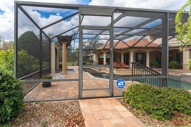 view of patio with a lanai and an outdoor pool