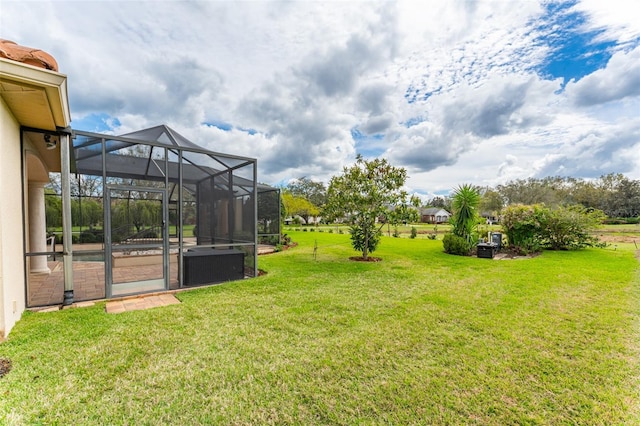 view of yard with a lanai and cooling unit