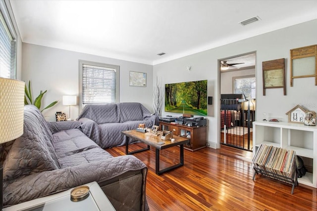 living area featuring plenty of natural light, wood finished floors, and visible vents