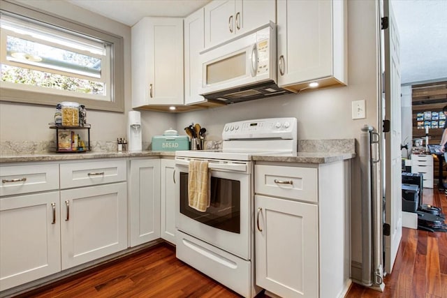 kitchen with light stone counters, white appliances, dark wood-style flooring, and white cabinetry