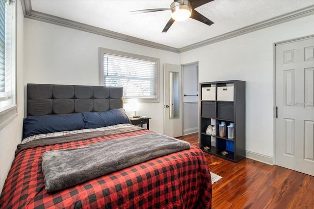 bedroom featuring ornamental molding, dark wood-style flooring, and baseboards