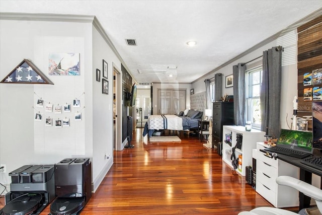 interior space featuring ornamental molding, wood finished floors, and visible vents