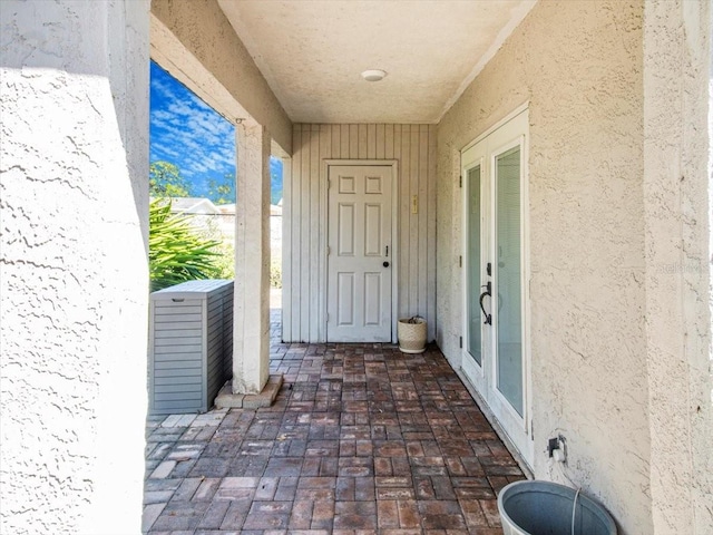 view of exterior entry featuring stucco siding