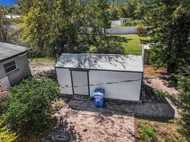 view of shed featuring fence