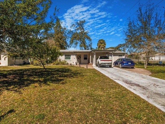 single story home with concrete driveway and a front yard