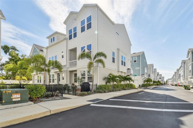 view of road with sidewalks, a residential view, and curbs