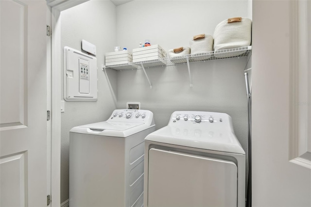 laundry area with washing machine and clothes dryer and laundry area