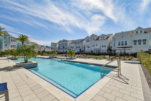 pool featuring a patio area and a residential view