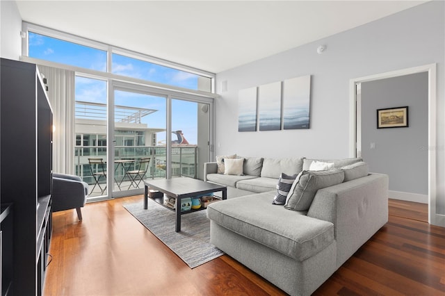 living room featuring a wall of windows, wood finished floors, and baseboards