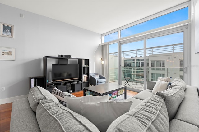 living room with expansive windows, wood finished floors, and baseboards