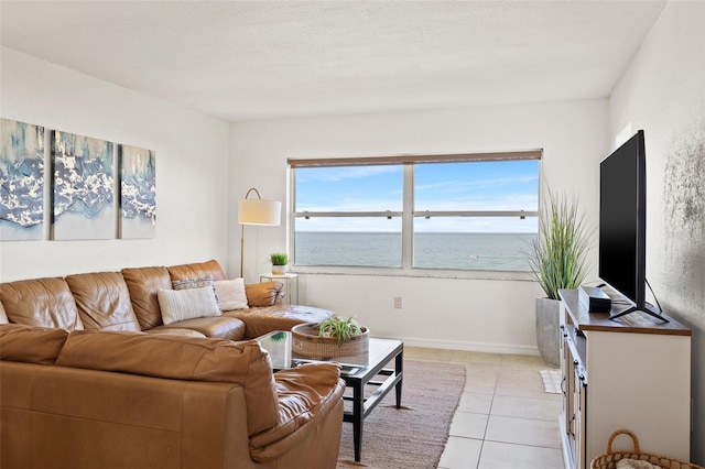 living area featuring light tile patterned floors and baseboards