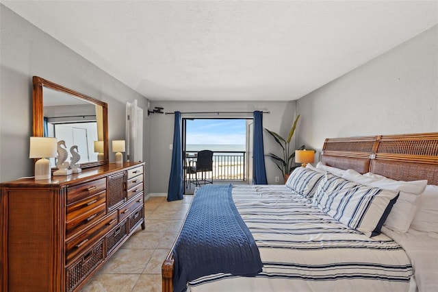 bedroom with access to outside and light tile patterned floors