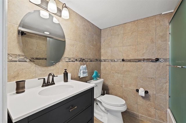 bathroom featuring an enclosed shower, tile walls, toilet, and vanity