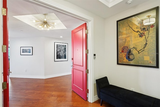 hallway featuring recessed lighting, a chandelier, baseboards, and wood finished floors