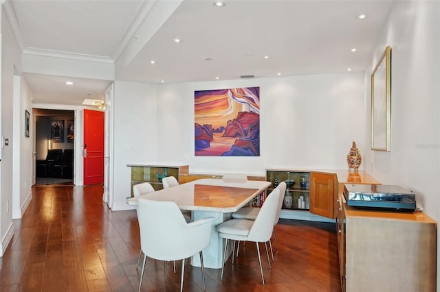 dining area with recessed lighting, ornamental molding, and dark wood-style flooring