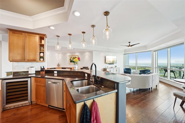 kitchen with brown cabinets, beverage cooler, a sink, stainless steel dishwasher, and open floor plan