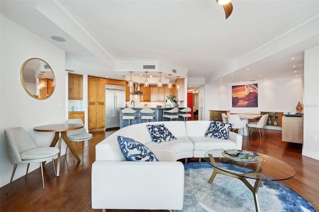 living room with visible vents, wood finished floors, recessed lighting, crown molding, and baseboards