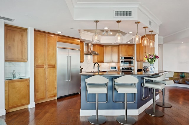 kitchen with stainless steel appliances, visible vents, crown molding, and wall chimney range hood