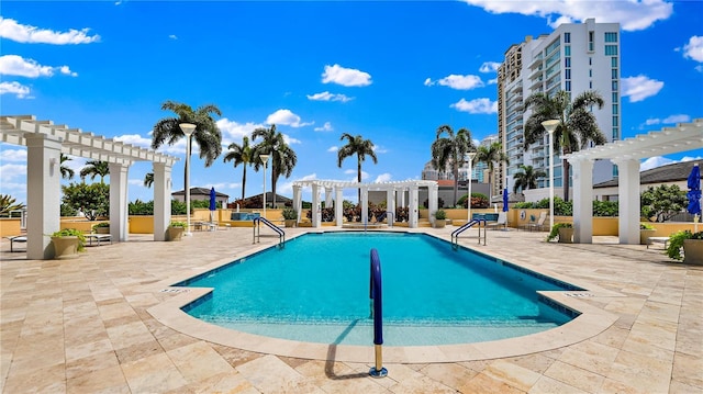 pool with a patio and a pergola