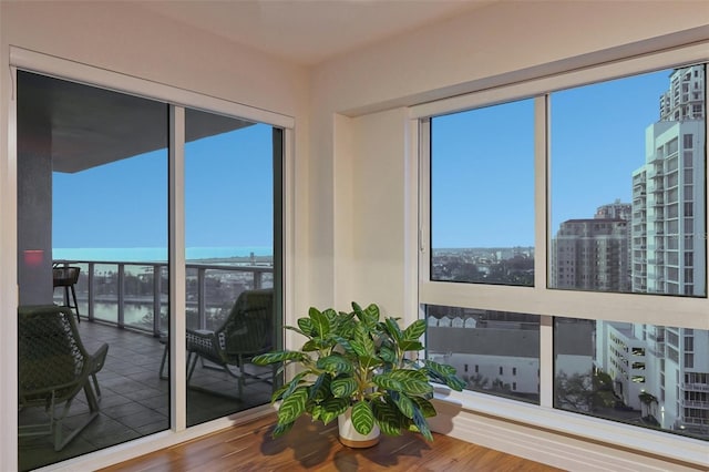 sunroom featuring a view of city and plenty of natural light