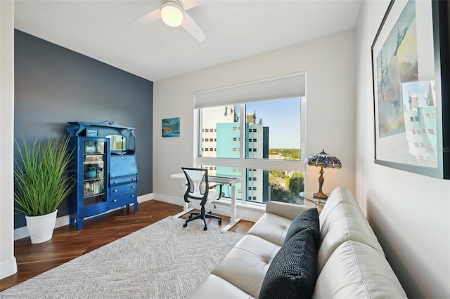 office space featuring baseboards, wood finished floors, and a ceiling fan