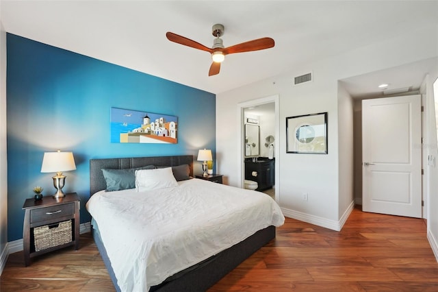 bedroom featuring visible vents, connected bathroom, baseboards, wood finished floors, and a ceiling fan