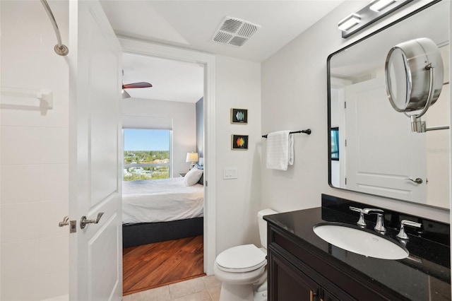 ensuite bathroom with vanity, visible vents, tile patterned flooring, ensuite bathroom, and toilet