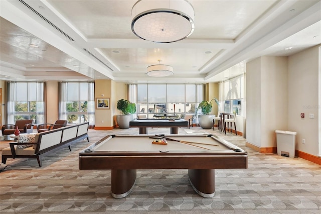 recreation room with a tray ceiling and baseboards