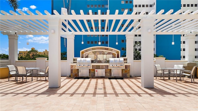 view of patio / terrace featuring grilling area, a pergola, exterior kitchen, and outdoor dining area