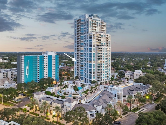 property at dusk with a city view