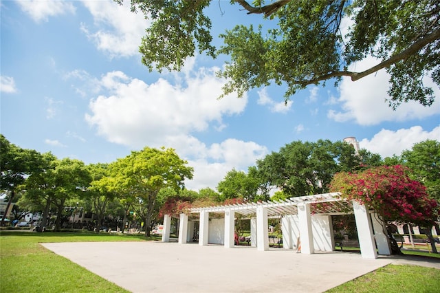 surrounding community with a lawn and a pergola