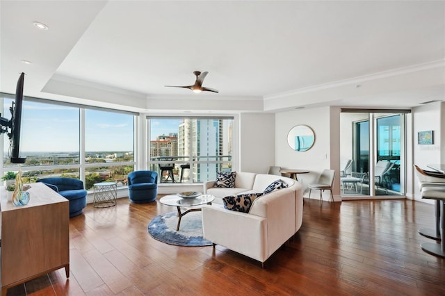 living area featuring recessed lighting, hardwood / wood-style floors, a ceiling fan, and crown molding