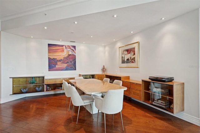 dining space with dark wood-type flooring and recessed lighting
